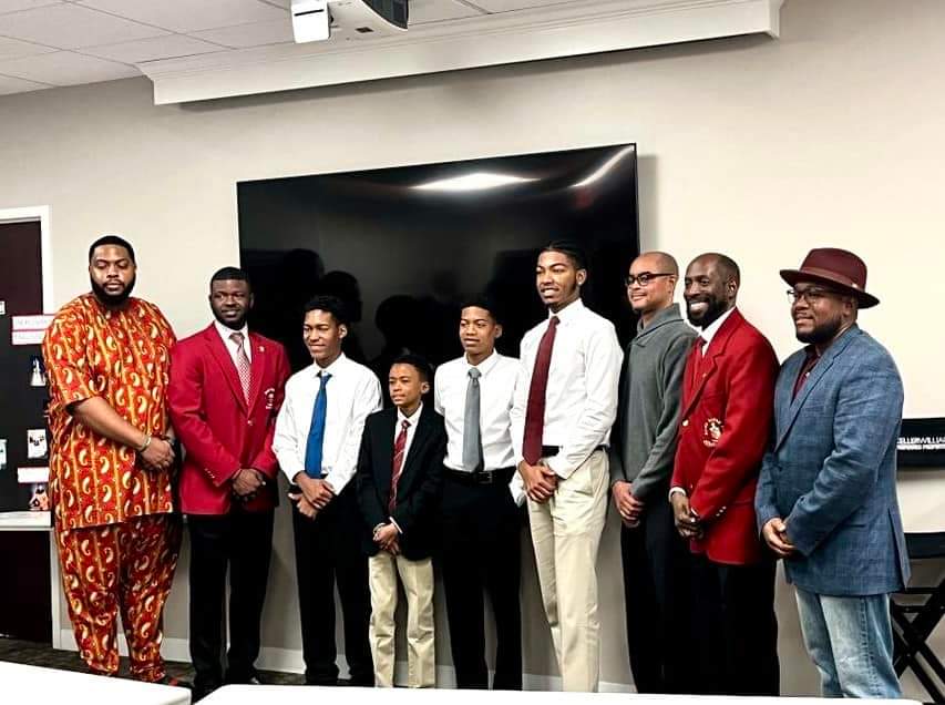MKYF A group of men posing for a picture in a conference room, celebrating their accomplishments with a sense of innovation and congratulations.