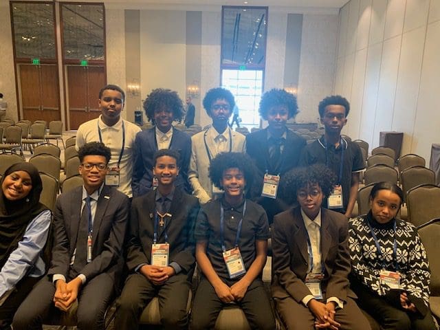 MKYF Group of students at a conference event, wearing formal attire and name tags.
