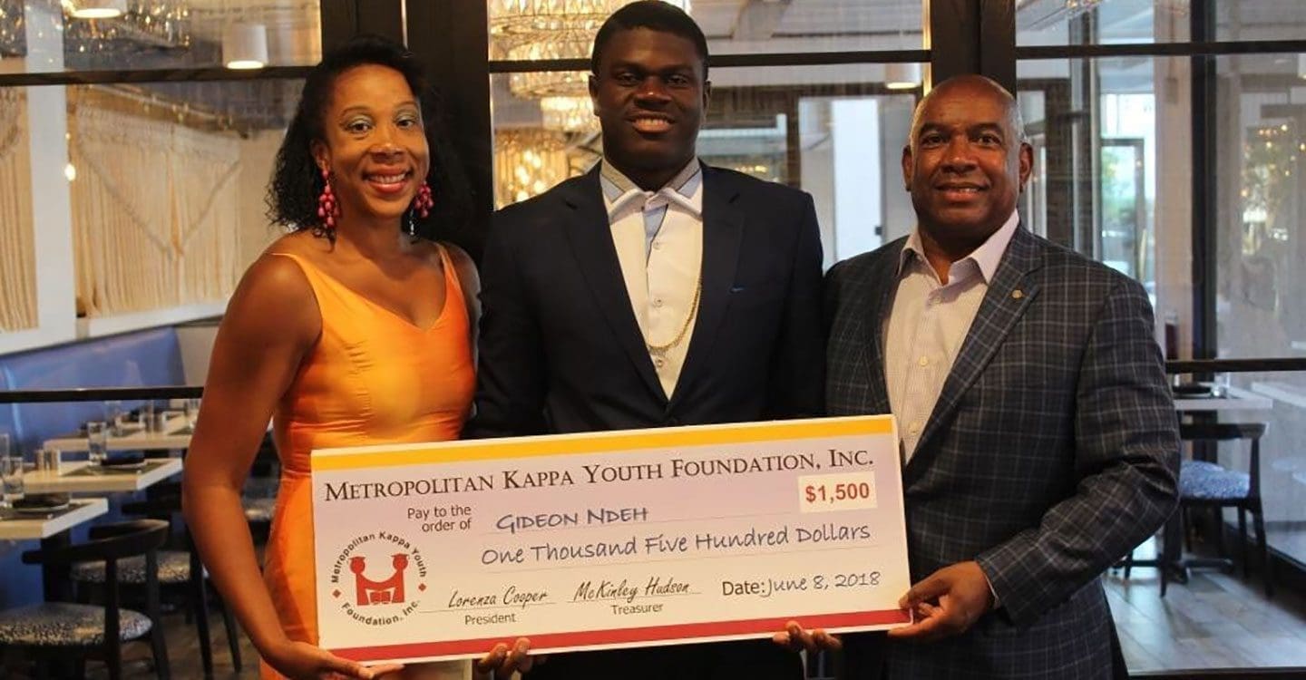 Scholarship Recipient holding enlarged check
